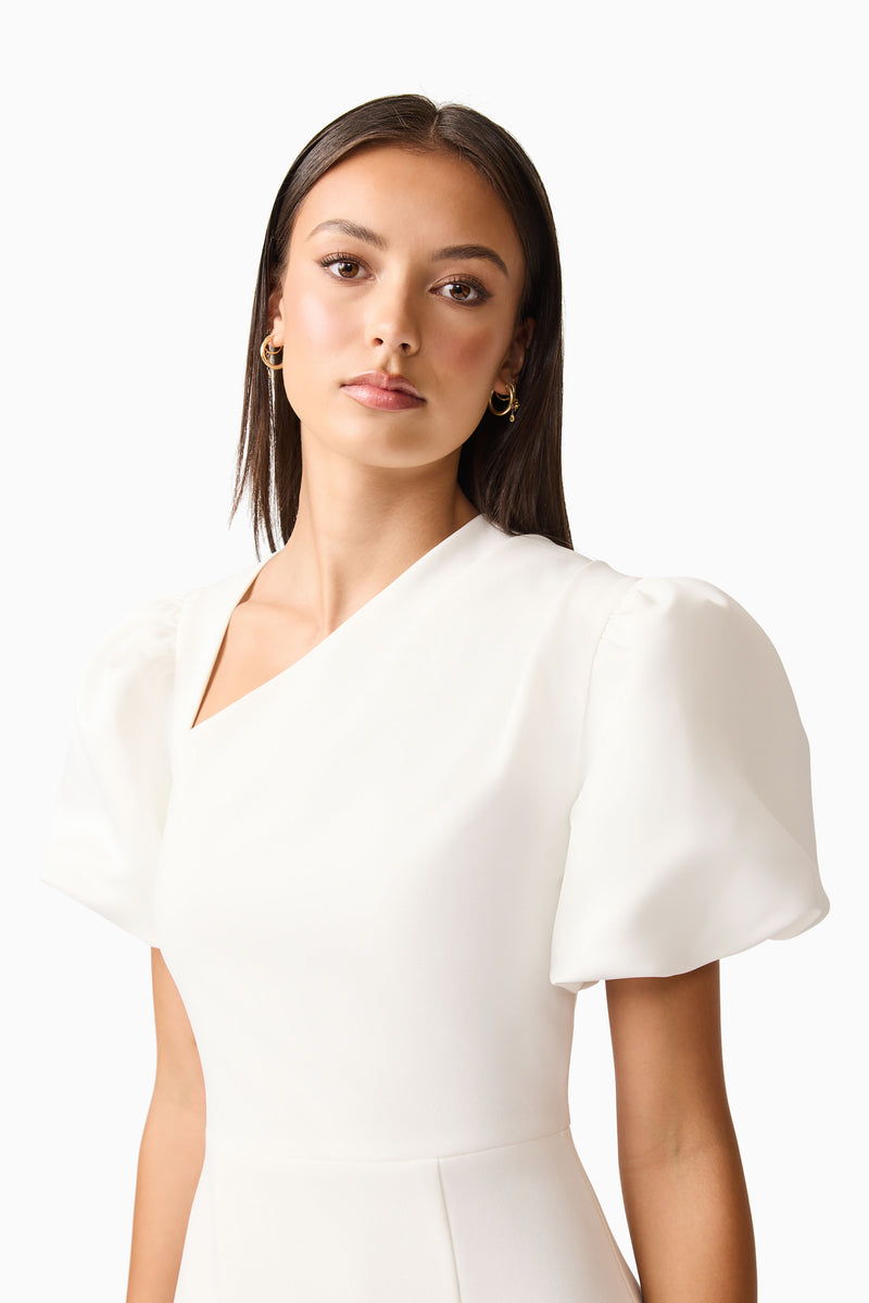 Brunette model wearing the Hester Puff Sleeve Midi Dress in White detail shot