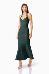 Virella Halter Gown in Dark Green with a v-neckline & mermaid skirt walking shot