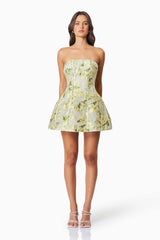 Brunette model wearing the Darner Strapless Mini Dress in Green Floral front shot