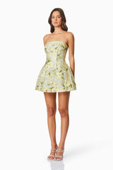Brunette model wearing the Darner Strapless Mini Dress in Green Floral side shot