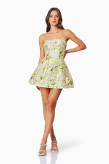 Brunette model wearing the Darner Strapless Mini Dress in Green Floral posed shot