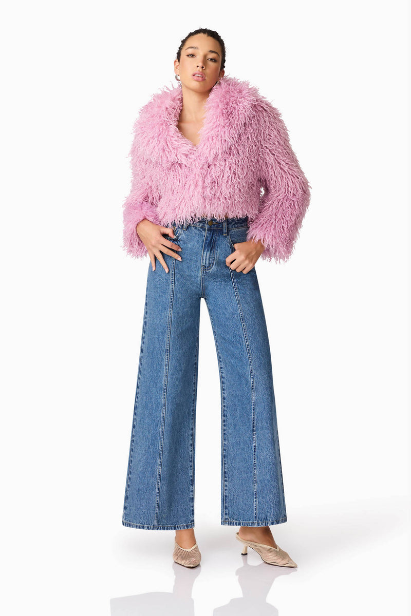 Brunette model wears Trisha Faux Fur Cropped Jacket in Pink Posed Shot
