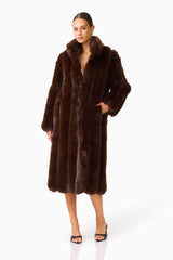 Camore Fur Coat in Brown with long sleeves psoed hand on hip shot