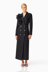 Noiretta Coat in Black with floral applique detailing & front side pockets posed looking away shot 