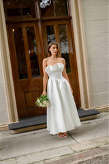 Brunette model wearing the Laurel Sleeveless Maxi Dress in Pearl White campaign shot