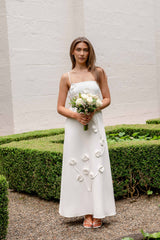 Brunette model wearing Nolana Floral Applique Gown in White campaign shot