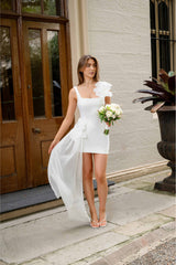 Brunette model wearing Janelle Party Mini Dress In White campaign shot