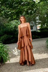 Brunette model wearing the Tilly Tiered Maxi Dress in Brown campaign shot 