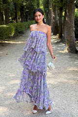 Brunette model wearing Milena Strapless Maxi Dress in Purple Floral outside posed shot