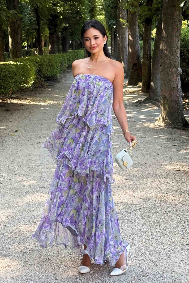 Brunette model wearing Milena Strapless Maxi Dress in Purple Floral outside posed shot