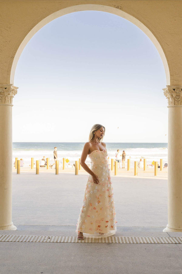 Brunette model wears Livia Maxi Dress in White campaign view