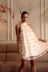 Brunette model wears Livia Trapeze Mini Dress in White campaign posed shot