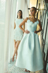 Brunette model wearing the Tula Gown in White inside campaign shot