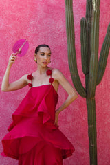 Brunette model wears the Thalia Tiered Gown in Pink next to a cactus