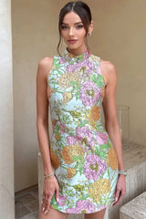 Brunette Model posing wearing the Sunbeam Mini Dress in Green Floral