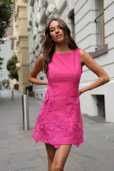 Brunette model wears the Janelle Mini in Pink on sidewalk