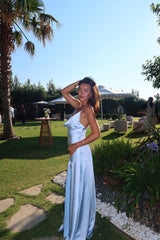 Model wears Clementine Cowl Neck Gown in Pale Blue to a destination wedding 