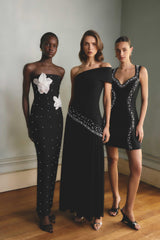 Model wears the Natasia Off Shoulder Gown in Black to winter wedding 