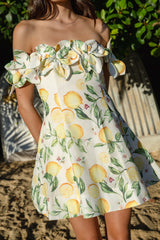 Brunette model wearing Hana Off Shoulder Mini Dress in Lemon Print content shot