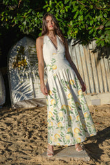 Brunette model wearing the Hana Halter Gown in Lemon Print content shot