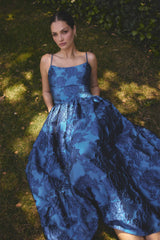 Model wearing the Sorelle A-Line Maxi Gown in Cobalt Blue to garden wedding