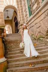 Brunette model wearing the Amelina Sash Gown in White campaign 