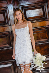Brunette model wearing the Rina Shift Mini Dress in White content shot