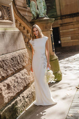 Brunette model wearing the Veda Embellished Gown in White campaign shot