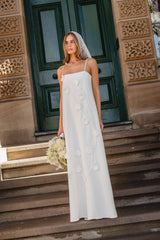 Brunette model wearing the Nolana Floral Applique Gown in White campaign shot