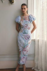 Brunette model wears the Priselle Puff Sleeve Midi Dress in Blue Floral campaign shot