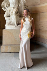 Blonde model wearing the Nicoletta High Neck Gown in Gold content shot