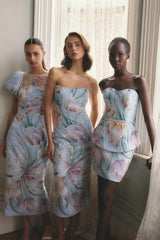 Brunette model wearing the Priselle Peplum Top & Mini Skirt Set in Blue Floral campaign shot