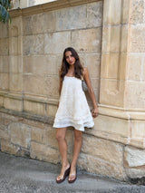 Brunette Influencer model wearing the Vessia Shift Mini Dress in White campaign Shot