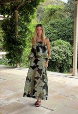 Brunette model wearing the Elysia Tiered Gown in Black & Green Floral campaign shot