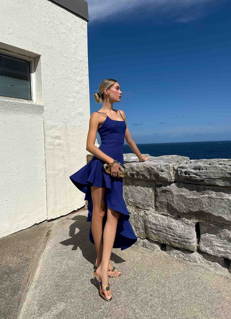 Brunette model wearing Beatrix Asymmetrical Gown in Blue campaign shot