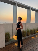 Brunette woman in the CURAAE Catiana Maxi Dress in Black campign shot