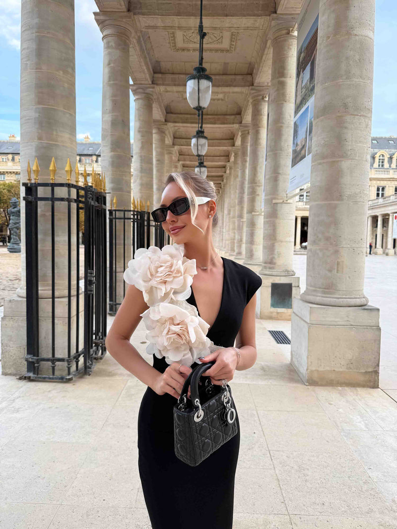 Blonde model wearing the Zahara V-Neck Gown in Black close up campaign shot