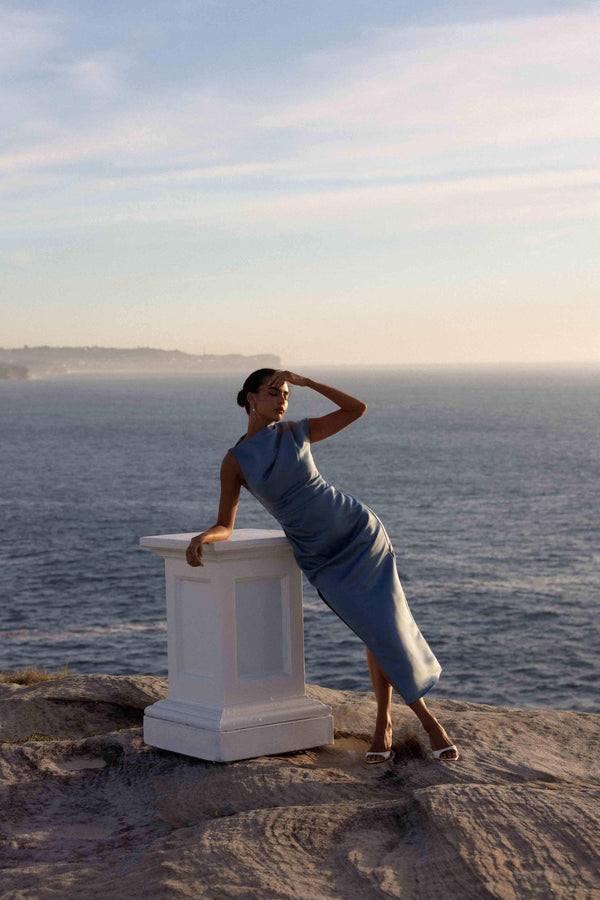 Brunette model wearing Coralie Maxi Gown in Blue posed campaign shot