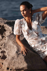 Brunette model wearing Zayla 3D Floral Mini Dress close up campaign shot