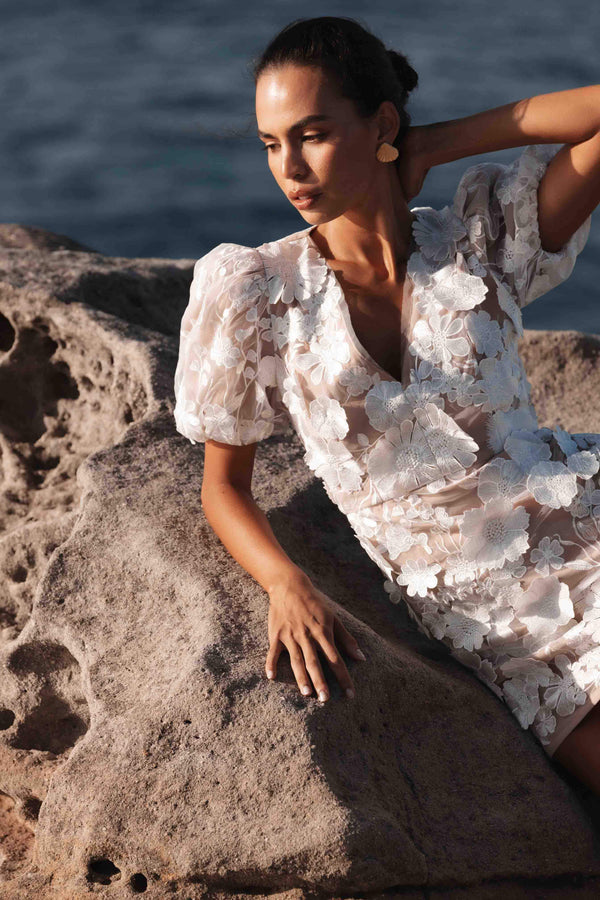Brunette model wearing Zayla 3D Floral Mini Dress close up campaign shot
