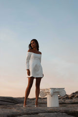 model wearing Vida Off The Shoulder Day Mini Dress In White campaign shot
