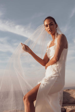 Blonde model wearing Emberlyn Gown in White campaign close up posed shot