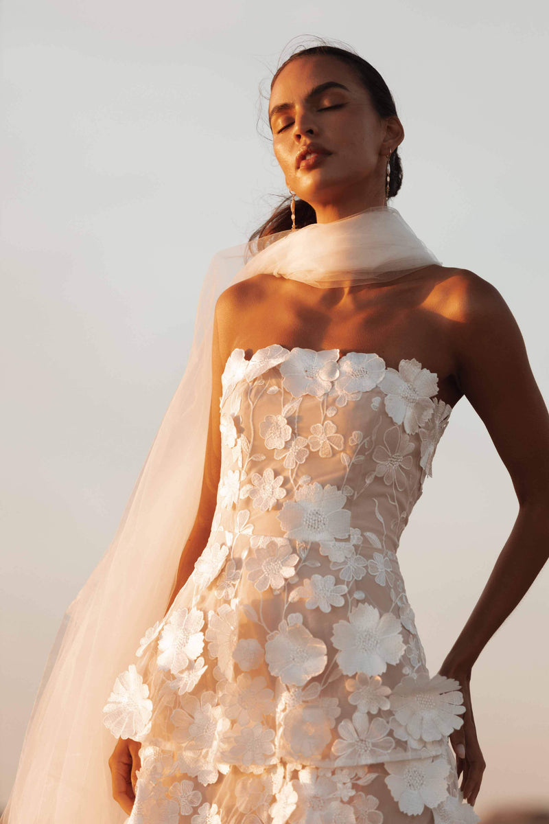 Brunette model wearing Selene Maxi Tiered 3D Dress in White close up campaign shot