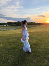Brunette model wearing the Tulsia Floral Cape Maxi Dress in Light Blue campaign shot