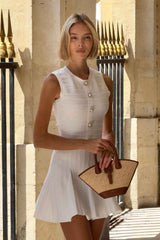 Blonde model wearing Fiona Mini Dress in White outside shot