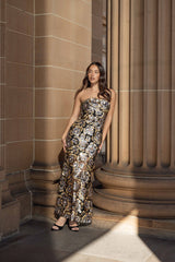 Celeste Strapless Gown in Black and Gold campaign looking away shot