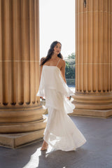 Brunette model wearing Moss Tiered Gown in White posed campaign shot
