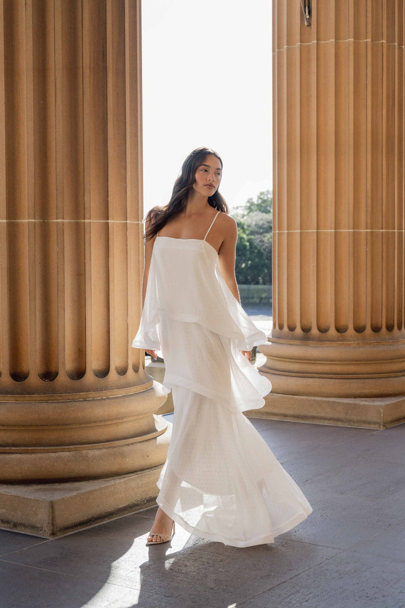 Brunette model wearing Moss Tiered Gown in White posed campaign shot