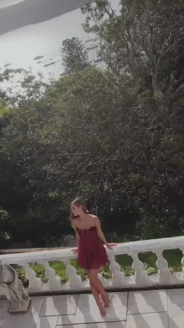 Brunette model wearing Carmen A-Line Mini Dress in Red campaign shot