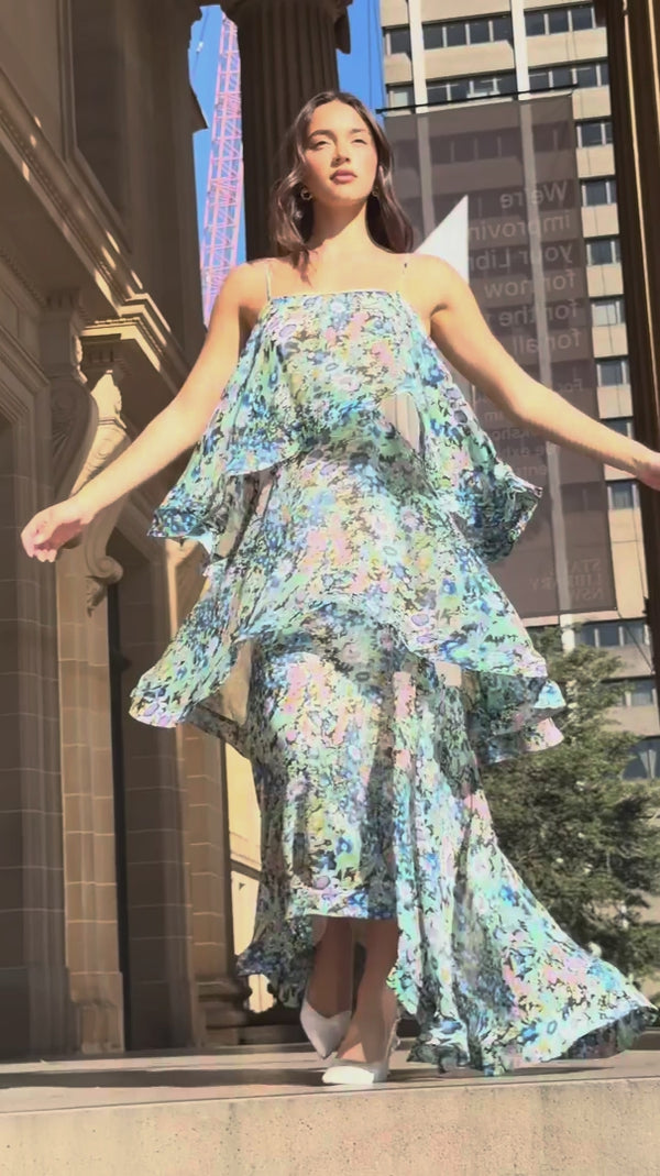 Brunette model wearing the Armani Tiered Maxi Dress In Blue Floral campaign video